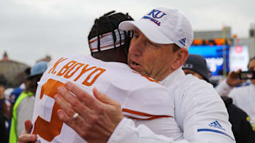Nov 23, 2018; Lawrence, KS, USA; Kansas Jayhawks head coach David Beaty hugs Texas Longhorns defensive back Kris Boyd (2) after the game at Memorial Stadium. Mandatory Credit: Jay Biggerstaff-Imagn Images