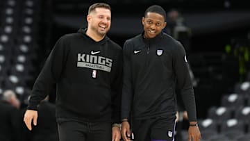 Nov 24, 2024; Sacramento, California, USA; Sacramento Kings guard De'Aaron Fox (right) and assistant coach Luke Loucks (left) talk before the game against the Brooklyn Nets at Golden 1 Center. Mandatory Credit: Darren Yamashita-Imagn Images