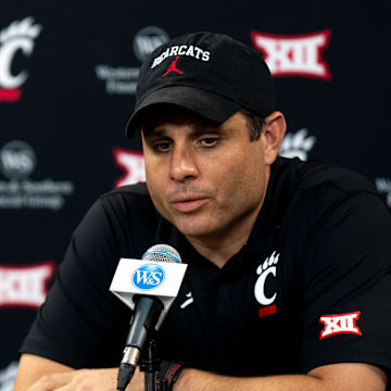 Cincinnati Bearcats head coach Wes Miller speaks at a podium at First Third Arena in Cincinnati on Wednesday, July 16, 2025.