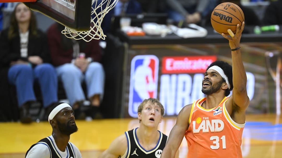 Nov 17, 2025; Cleveland, Ohio, USA; Cleveland Cavaliers center Jarrett Allen (31) shoots beside Milwaukee Bucks guard AJ Green (20) and forward Bobby Portis (9) in the third quarter at Rocket Arena. Mandatory Credit: David Richard-Imagn Images