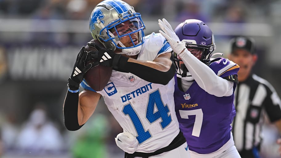 Oct 20, 2024; Minneapolis, Minnesota, USA; Detroit Lions wide receiver Amon-Ra St. Brown (14) catches a 35 yard touchdown pass from quarterback Jared Goff (not pictured) as Minnesota Vikings cornerback Byron Murphy Jr. (7) defends during the second quarter at U.S. Bank Stadium. | Jeffrey Becker-Imagn Images