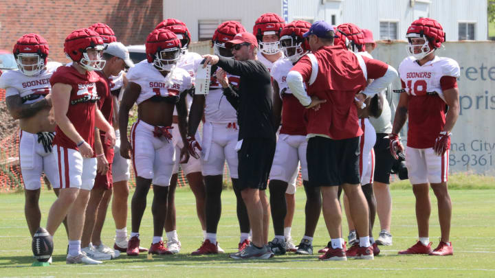 Oklahoma special teams analyst Doug Deakin coaching the Sooners through kickoff coverage drills during a practice at fall camp.