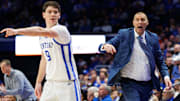 Nov 21, 2025; Lexington, Kentucky, USA; Kentucky Wildcats head coach Mark Pope calls out to his players while forward Trent Noah (9) directs his teammates during the second half against the Loyola (MD) Greyhounds at Rupp Arena at Central Bank Center. Mandatory Credit: Jordan Prather-Imagn Images
