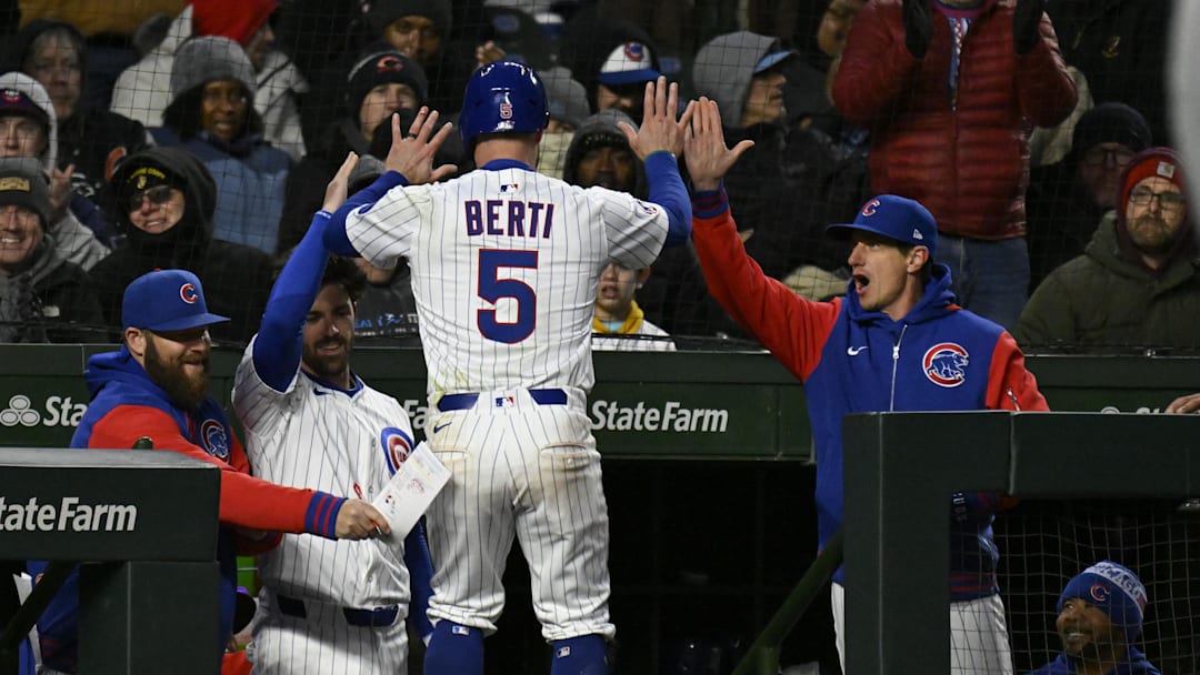 Apr 7, 2025; Chicago, Illinois, USA;  Chicago Cubs third baseman Jon Berti (5) high fives manager Craig Counsell (11) after he scores against the Texas Rangers  during the third inning at Wrigley Field. Mandatory Credit: Matt Marton-Imagn Images