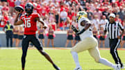Oct 5, 2024; Raleigh, North Carolina, USA;  North Carolina State Wolfpack quarterback CJ Bailey (16) throws the ball during the first half of the game against Wake Forest Demon Deacons at Carter-Finley Stadium. Mandatory Credit: Jaylynn Nash-Imagn Images