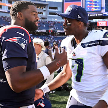 Sep 15, 2024; Foxborough, Massachusetts, USA; New England Patriots quarterback Jacoby Brissett (7) talks with Seattle Seahawks quarterback Geno Smith (7) after a game  at Gillette Stadium.