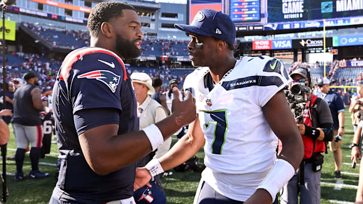 Sep 15, 2024; Foxborough, Massachusetts, USA; New England Patriots quarterback Jacoby Brissett (7) talks with Seattle Seahawks quarterback Geno Smith (7) after a game  at Gillette Stadium.