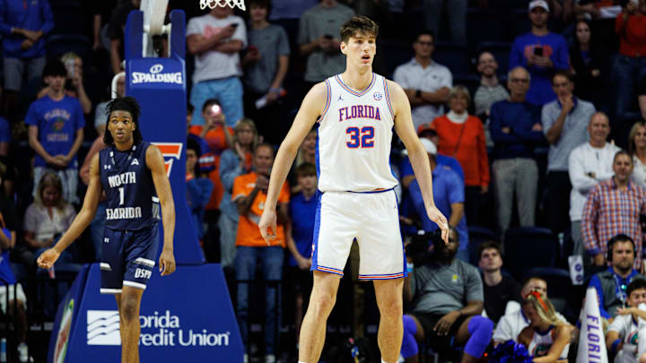 Nov 6, 2025; Gainesville, Florida, USA; Florida Gators center Olivier Rioux (32) defends while North Florida Ospreys forward BJ Plummer (1) looks on during the second half at Exactech Arena at the Stephen C. O'Connell Center. Mandatory Credit: Matt Pendleton-Imagn Images