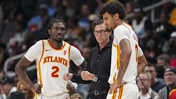 Atlanta Hawks head coach Quin Snyder talks to guard Keaton Wallace (2) and forward Dominick Barlow (0) during the game against the Orlando Magic during the second half at State Farm Arena.