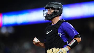 Sep 24, 2024; Denver, Colorado, USA; Colorado Rockies catcher Jacob Stallings (25) during a run down in the seventh inning against the St. Louis Cardinals at Coors Field. Mandatory Credit: Ron Chenoy-Imagn Images