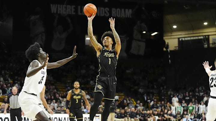 Feb 15, 2025; Boulder, Colorado, USA; UCF Knights guard Mikey Williams (1) shoots the ball over Colorado Buffaloes forward Assane Diop (35) in the first half at the CU Events Center. Mandatory Credit: Ron Chenoy-Imagn Images