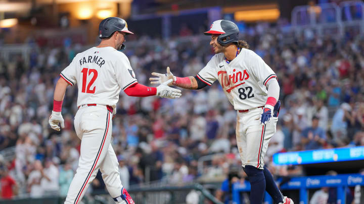 Minnesota Twins second baseman Kyle Farmer (12) celebrates his home run with second baseman Austin Martin (82) against the Kansas City Royals in the seventh inning at Target Field in Minneapolis on Aug. 13, 2024.