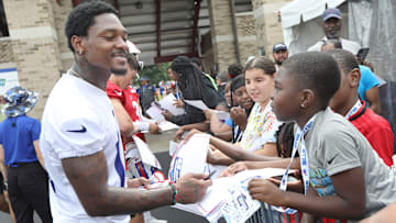 Receiver Stefon Diggs has fun with young fans as he signs autographs on the fourth day of the Buffalo Bills training camp at St. John Fisher University.