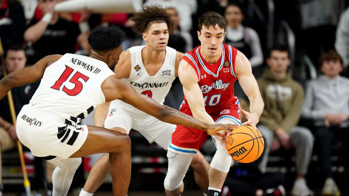 Bradley Braves guard Connor Hickman (10) maintains possession as Cincinnati Bearcats forward John Newman III (15) goes for the steal in the first half of a college basketball game during a second-round game of the National Invitation Tournament,, Saturday, March 23, 2024, at Fifth Third Arena in Cincinnati.