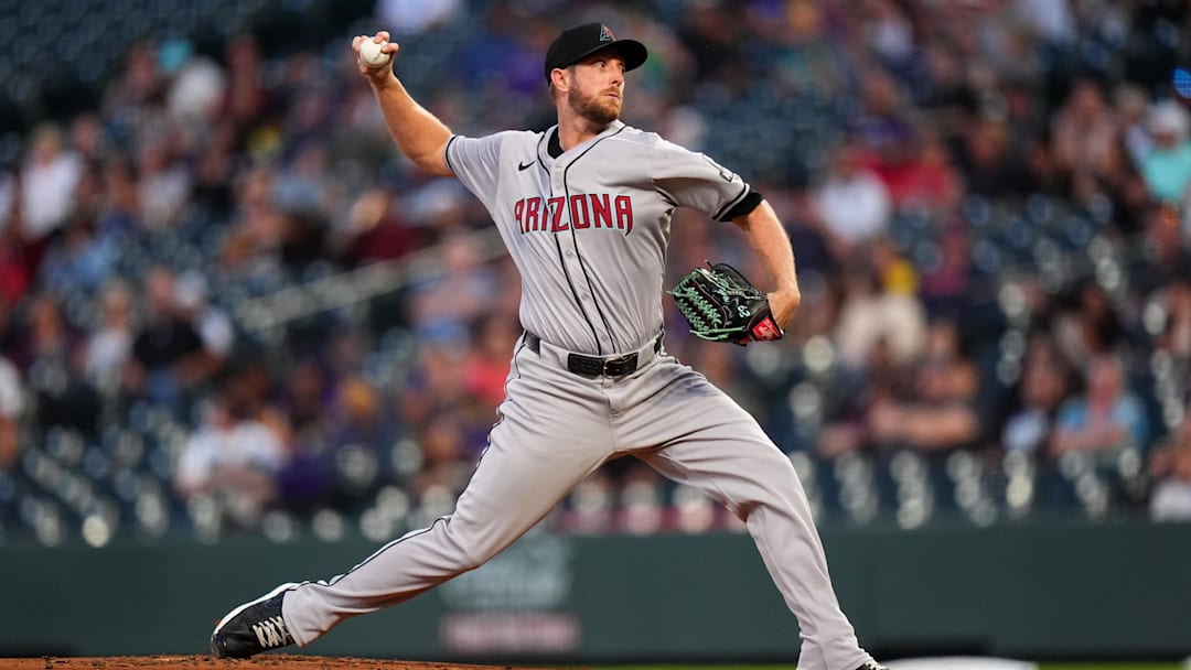 Sep 16, 2024; Denver, Colorado, USA;  Arizona Diamondbacks starting pitcher Merrill Kelly (29) delivers a pitch in the first inning against the Colorado Rockies at Coors Field. Mandatory Credit: Ron Chenoy-Imagn Images