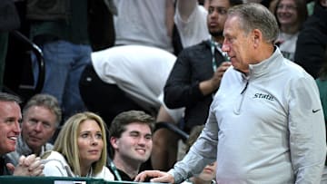 Dec 2, 2025; East Lansing, Michigan, USA;  MSU’s new football coach, Pat Fitzgerald(left) chats with at Michigan State Spartans head coach Tom Izzo during their game against Iowa at Jack Breslin Student Events Center. Mandatory Credit: Dale Young-Imagn Images