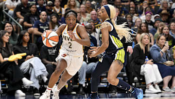 Aug 1, 2025; Dallas, Texas, USA;  Indiana Fever guard Aari McDonald (2) drives to the basket past Dallas Wings guard DiJonai Carrington (21) during the second half at the American Airlines Center. Mandatory Credit: Jerome Miron-Imagn Images