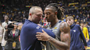 Mar 8, 2025; Morgantown, West Virginia, USA; West Virginia Mountaineers head coach Darian DeVries and guard Javon Small (7) celebrate after defeating the UCF Knights at WVU Coliseum. Mandatory Credit: Ben Queen-Imagn Images