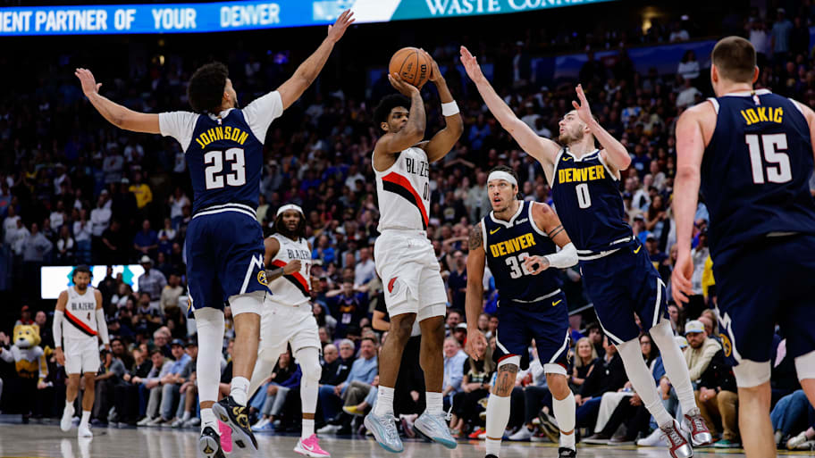 Portland Trail Blazers guard Scoot Henderson attempts a shot as Denver Nuggets forward Cam Johnson defends.