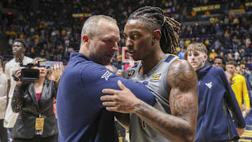 Mar 8, 2025; Morgantown, West Virginia, USA; West Virginia Mountaineers head coach Darian DeVries and guard Javon Small (7) celebrate after defeating the UCF Knights at WVU Coliseum. Mandatory Credit: Ben Queen-Imagn Images