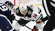 Jan 20, 2025; Denver, Colorado, USA; Minnesota Wild center Joel Eriksson Ek (14) prepares to take a face off  in the third period against the Colorado Avalanche at Ball Arena. Mandatory Credit: Ron Chenoy-Imagn Images