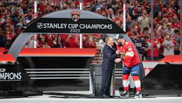 Jun 17, 2025; Sunrise, Florida, USA; Gary Bettman, NHL Commissioner, presents Florida Panthers center Sam Bennett (9) the Conn Smythe Trophy after winning game six of the 2025 Stanley Cup Final against the Edmonton Oilers at Amerant Bank Arena. Mandatory Credit: Sam Navarro-Imagn Images