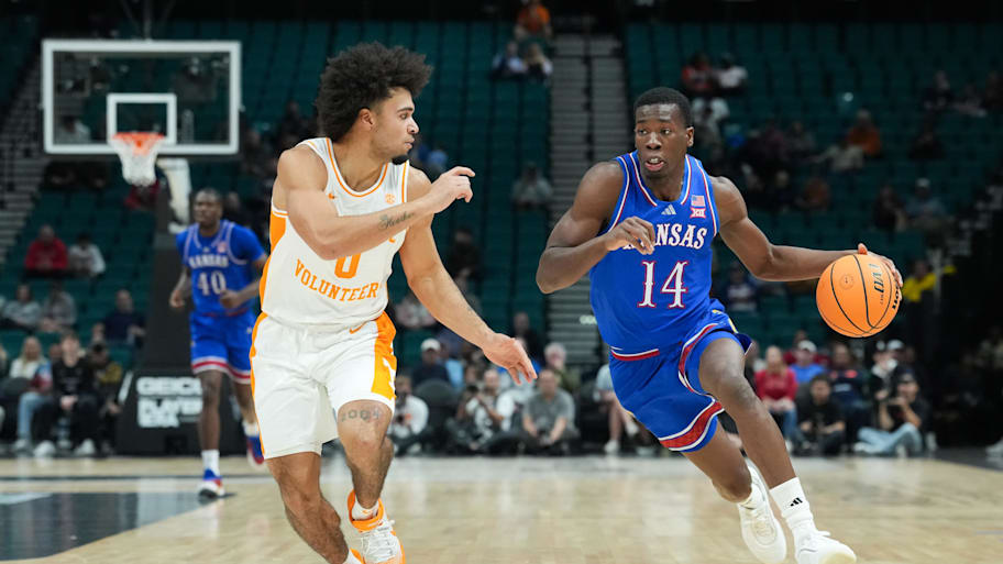 Kansas guard Melvin Council Jr. controls the ball while defended by Tennessee guard Ja’Kobi Gillespie.