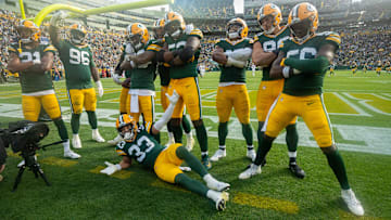 Green Bay Packers safety Evan Williams (33) and his teammate pose for a photo after a fumble recovery during the third quarter of their game Sunday, October 13, 2024 at Lambeau Field in Green Bay, Wisconsin. The Green Bay Packers beat the Arizona Cardinals 34-13.