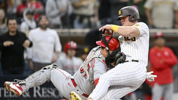 Cincinnati Reds catcher Tyler Stephenson collides with San Diego Padres Luke Voit.