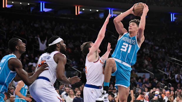 Charlotte Hornets forward Tidjane Salaun (31) shoots the ball while being defended by New York Knicks guard Tyler Kolek (13) 