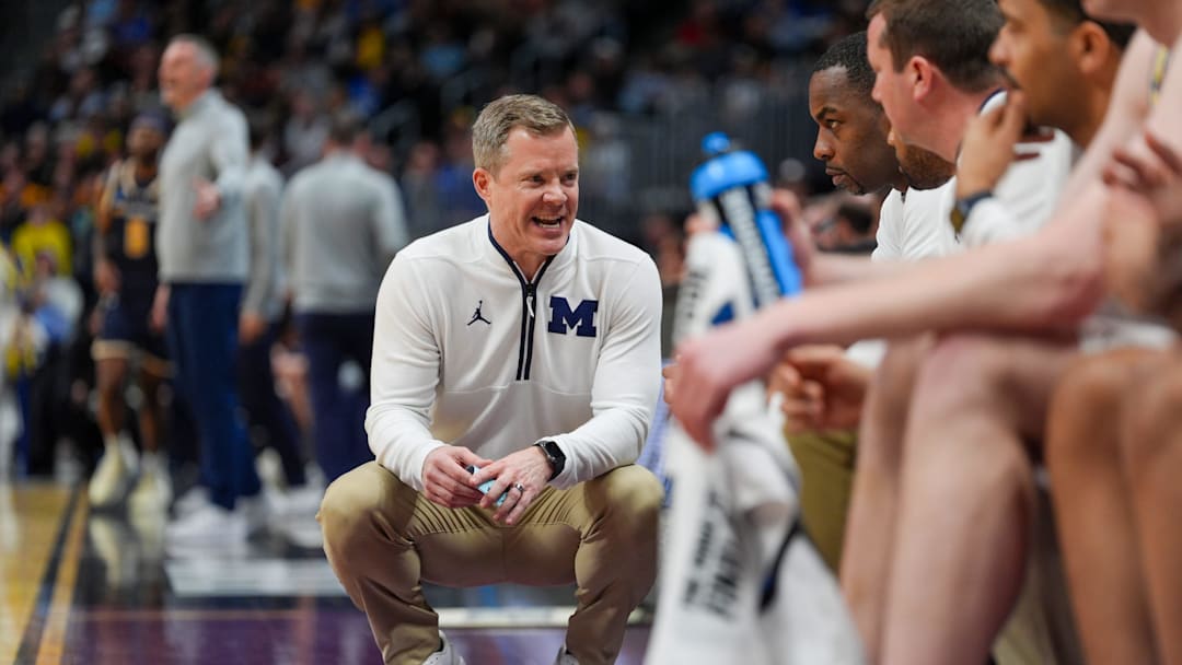 Michigan Wolverines head coach Dusty May talks to his asst. coaches during the second period of the first round of the NCAA tournament at Ball Arena in Denver, Colorado for .