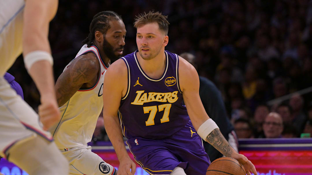 Nov 25, 2025; Los Angeles, California, USA; Los Angeles Lakers guard Luka Doncic (77) drives past Los Angeles Clippers forward Kawhi Leonard (2) during the first half at Crypto.com Arena. Mandatory Credit: Jayne Kamin-Oncea-Imagn Images