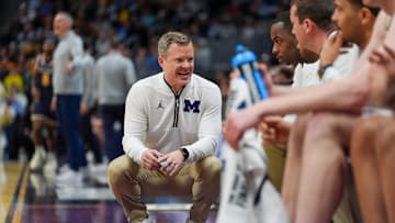Michigan Wolverines head coach Dusty May talks to his asst. coaches during the second period of the first round of the NCAA tournament at Ball Arena in Denver, Colorado for .