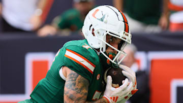 Nov 2, 2024; Miami Gardens, Florida, USA; Miami Hurricanes wide receiver Xavier Restrepo (7) catches the football for a touchdown against the Duke Blue Devils during the first quarter at Hard Rock Stadium. Mandatory Credit: Sam Navarro-Imagn Images