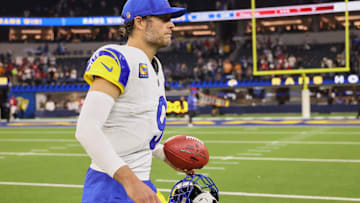 Nov 23, 2025; Inglewood, California, USA; Los Angeles Rams quarterback Matthew Stafford (9) walks off the field with a game ball after the game against the Tampa Bay Buccaneers at SoFi Stadium. Mandatory Credit: Kiyoshi Mio-Imagn Images