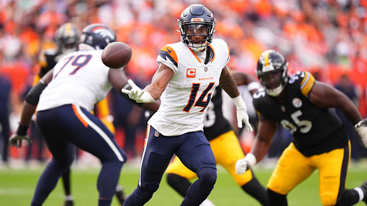 Sep 15, 2024; Denver, Colorado, USA; Denver Broncos wide receiver Courtland Sutton (14) passes the ball backward in the third quarter against the Pittsburgh Steelers at Empower Field at Mile High. 