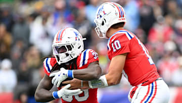 Oct 13, 2024; Foxborough, Massachusetts, USA; New England Patriots quarterback Drake Maye (10) hands the ball off to running back JaMycal Hasty (39 during the first half of a game against the Houston Texans at Gillette Stadium. Mandatory Credit: Brian Fluharty-Imagn Images
