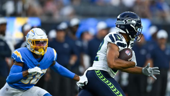 Aug 10, 2024; Inglewood, California, USA; Seattle Seahawks wide receiver Cody White (82) runs the ball against Los Angeles Chargers cornerback Chris Wilcox (38) during the fourth quarter at SoFi Stadium. Mandatory Credit: Jonathan Hui-USA TODAY Sports