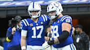 Nov 30, 2025; Indianapolis, Indiana, USA;  Indianapolis Colts quarterback Daniel Jones (17) and guard Dalton Tucker (68) warm up before a game against the Houston Texans at Lucas Oil Stadium. 