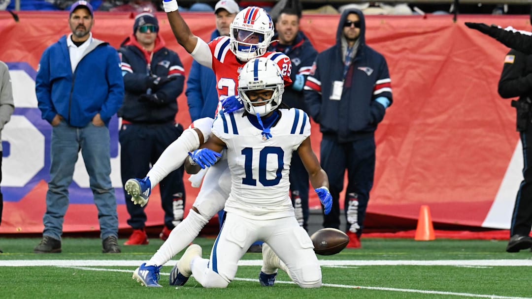 Dec 1, 2024; Foxborough, Massachusetts, USA; New England Patriots cornerback Marcus Jones (25) reacts to breaking up a pass to Indianapolis Colts wide receiver Adonai Mitchell (10) during the second half at Gillette Stadium. Mandatory Credit: Eric Canha-Imagn Images