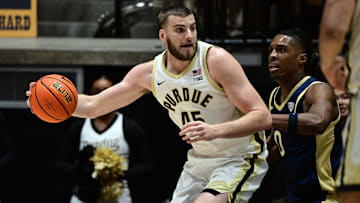 Purdue Boilermakers center Oscar Cluff (45) leans in against Akron Zips forward Amani Lyles (0) 