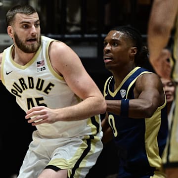 Purdue Boilermakers center Oscar Cluff (45) leans in against Akron Zips forward Amani Lyles (0) 