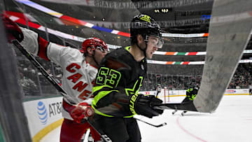 Jan 21, 2025; Dallas, Texas, USA; Carolina Hurricanes left wing Jordan Martinook (48) and Dallas Stars center Wyatt Johnston (53) look for the puck in the Dallas zone during the third period at the American Airlines Center. Mandatory Credit: Jerome Miron-Imagn Images