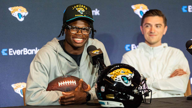 The Jacksonville Jaguars’ first-round pick, Colorado Buffaloes wide receiver and defensive back Travis Hunter, left, answers 
