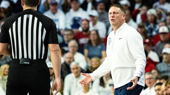 Penn State basketball coach Mike Rhoades argues a call with the referee