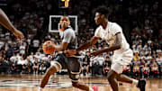 Nov 8, 2024; College Station, Texas, USA; East Texas A&M guard Evan Phelps (2) looks to pass the ball as Texas A&M Aggies forward Chris McDermott (14) defends during the second half at Reed Arena. The Aggies defeated the Lions 87-55. Mandatory Credit: Maria Lysaker-Imagn Images 