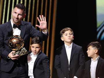 Lionel Messi and his three sons, Thiago, Ciro, and Mateo.