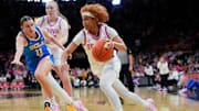 Iowa guard Aaliyah Guyton (11) drives toward the basket as UCLA guard Gabriela Jaquez (11) defends Sunday, Feb. 23, 2025 at Carver-Hawkeye Arena in Iowa City, Iowa.