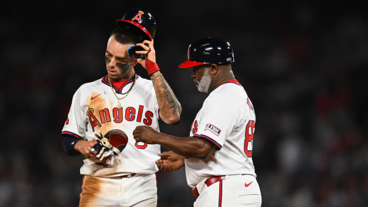 Jul 27, 2024; Anaheim, California, USA; Los Angeles Angels shortstop Zach Neto (9) reacts with third base coach Eric Young Sr. (85) after failing to steal second base against the Oakland Athletics during the seventh inning at Angel Stadium. Mandatory Credit: Jonathan Hui-USA TODAY Sports