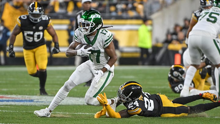 Oct 20, 2024; Pittsburgh, Pennsylvania, USA; NNew York Jets wide receiver Davante Adams (17) eludes Pittsburgh Steelers cornerback Joey Porter Jr. (24) on a pass during the first quarter at Acrisure Stadium. Mandatory Credit: Barry Reeger-Imagn Images